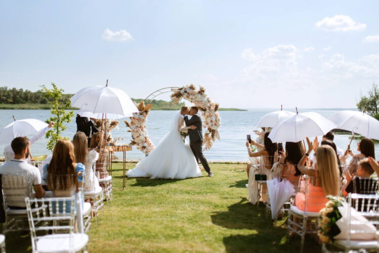 wedding ceremony of the newlyweds on the pier near the restaurant